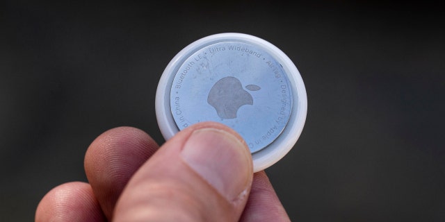 San Francisco, California - March 14, 2022: A man holds an Apple AirTag in San Francisco, California on March 14, 2022.