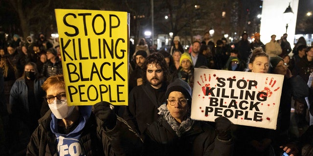 Demonstrators hold signs during a protest at Washington Square Park in New York City on Jan. 28, 2023, in response to the death of Tyre Nichols.