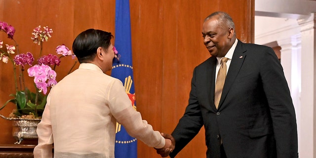 U.S. Secretary of Defense Lloyd James Austin III, right, shake hands with Philippine President Ferdinand Marcos Jr. during a courtesy call at the Malacanang Palace in Manila, Philippines on Thursday, Feb. 2, 2023. 