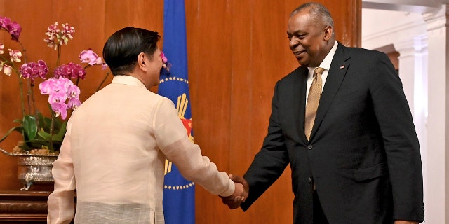 U.S. Secretary of Defense Lloyd James Austin III, right, shake hands with Philippine President Ferdinand Marcos Jr. during a courtesy call at the Malacanang Palace in Manila, Philippines on Thursday, Feb. 2, 2023.