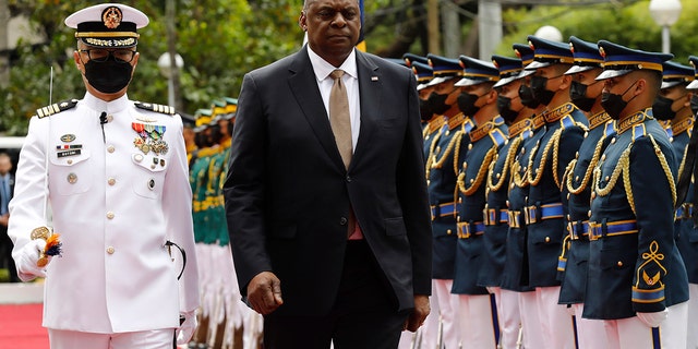 U.S. Defense Secretary Lloyd Austin, second from left, walks past military guards during his arrival at the Department of National Defense in Camp Aguinaldo military camp in Quezon City, Metro Manila, Philippines on Thursday February 2, 2023. 
