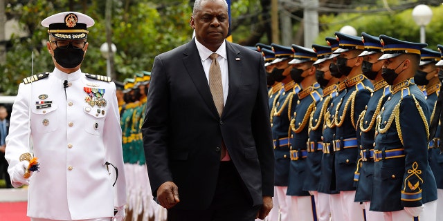 U.S. Defense Secretary Lloyd Austin, second from left, walks past military guards during his arrival at the Department of National Defense in Camp Aguinaldo military camp in Quezon City, Metro Manila, Philippines on Thursday February 2, 2023.