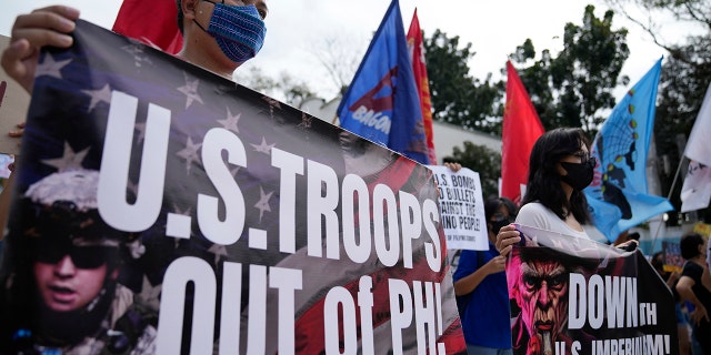 Demonstrators hold banners as they protest against the visit of U.S. Defense Secretary Lloyd Austin outside Camp Aguinaldo military headquarters in metro Manila, Philippines on Thursday, Feb. 2, 2023. 