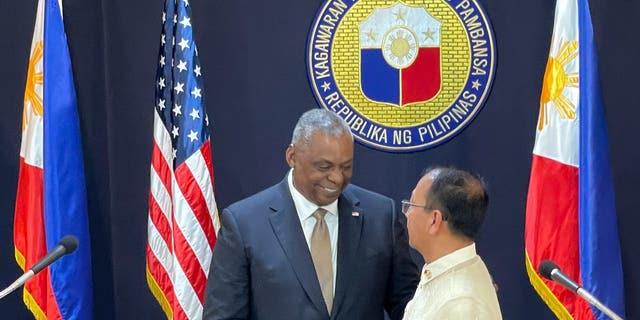 U.S. Defense Secretary Lloyd Austin, left, shakes hands with his Philippine counterpart, Carlito Galvez Jr. at a joint press conference in Camp Aguinaldo military headquarters in metro Manila, Philippines on Thursday, Feb. 2, 2023.