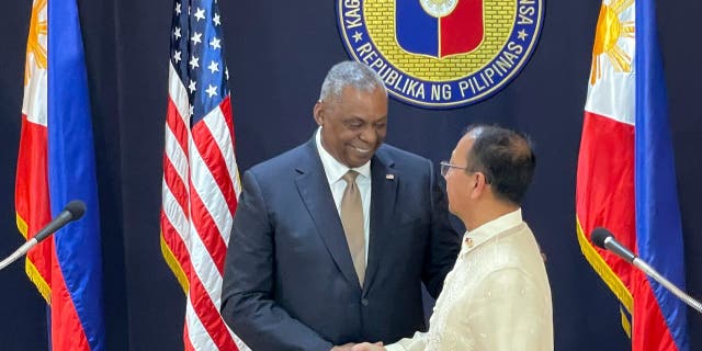 U.S. Defense Secretary Lloyd Austin, left, shakes hands with his Philippine counterpart, Carlito Galvez Jr. at a joint press conference in Camp Aguinaldo military headquarters in metro Manila, Philippines on Thursday, Feb. 2, 2023.