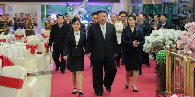 Kim Jong Un was also accompanied by his wife Ri Sol Ju, right, at a banquet to mark the 75th founding anniversary of the Korean People’s Army in North Korea Tuesday. 