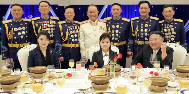 Kim Jong Un, with his wife Ri Sol Ju, left, and daughter Ju-ae poses with military officials to mark the 75th founding anniversary of the Korean People’s Army on Tuesday, Feb. 7, 2023.