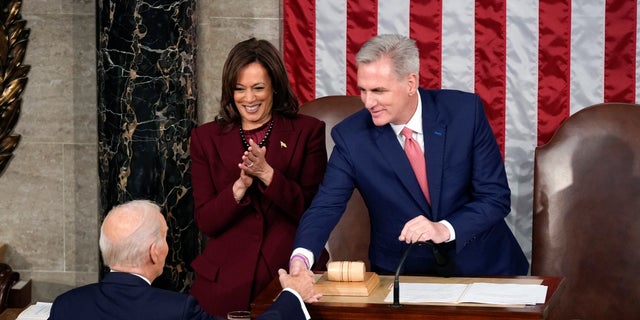President Joe Biden shakes hands with House Speaker Kevin McCarthy of Calif., as he arrives to deliver the State of the Union address to a joint session of Congress at the U.S. Capitol, Tuesday, Feb. 7, 2023, in Washington. Vice President Kamala Harris looks on. (AP Photo/Patrick Semansky)