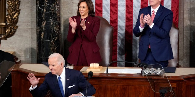 President Biden waves as he delivers the State of the Union address to a joint session of Congress at the U.S. Capitol, Tuesday, Feb. 7, 2023, in Washington. Vice President Kamala Harris and House Speaker Kevin McCarthy applaud.