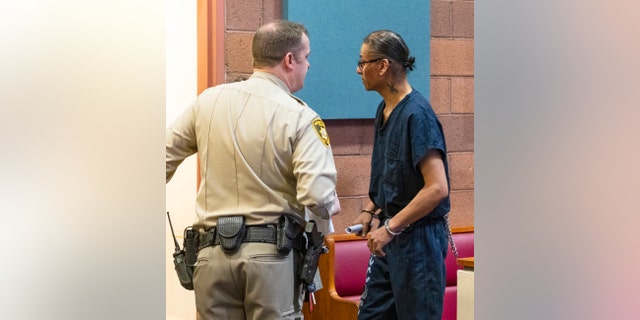 Former actor Nathan Lee Chasing His Horse, right, also known as Nathan Chasing Horse, is lead out of the courtroom after his bail hearing at North Las Vegas Justice Court.