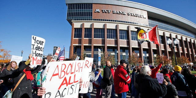 A "No Honor in Racism Rally" marches in front of TCF Bank Stadium before an NFL football game between the Minnesota Vikings and the Kansas City Chiefs, on Oct. 18, 2015, in Minneapolis. 