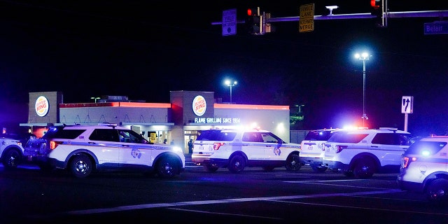 Police vehicles park in formation at an intersection checkpoint on Mountain Road and Belair Road where a suspected gunman is believed to be at large, Thursday, Feb. 9, 2023, in Fallston, Md.