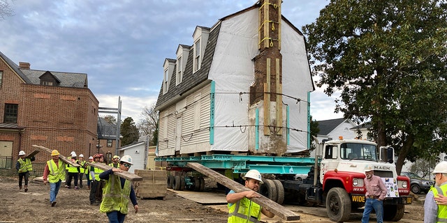 Workers prepare to move the original structure that held what is believed to be the oldest schoolhouse in the U.S. for Black children in Williamsburg, Virginia, on Friday, Feb. 10, 2023. 