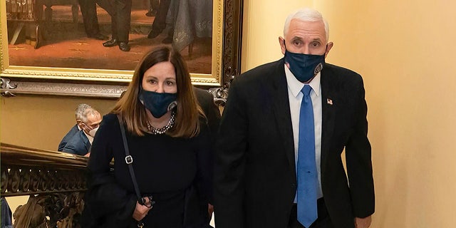 Former Vice President Mike Pence, seen walking in the Capitol with his wife Karen, has been subpoenaed as part of a special Justice Department investigation.