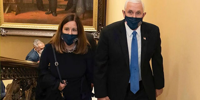 Former Vice President Mike Pence, seen walking in the Capitol with his wife Karen, has been subpoenaed as part of a special Justice Department investigation.