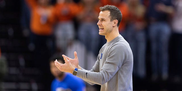 Duke head coach Jon Scheyer disagrees with a referee during the first half of an NCAA college basketball game against Virginia in Charlottesville, Virginia on Saturday, February 11, 2023.