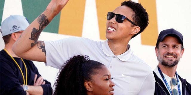 American professional basketball player Brittney Griner acknowledges fans as she watches on the 16th hole during the third round of the Phoenix Open golf tournament, Saturday, Feb. 11, 2023, in Scottsdale, Ariz. 