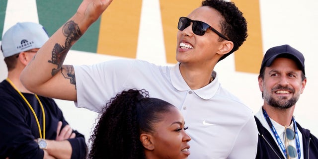 American professional basketball player Brittney Griner acknowledges fans as she watches on the 16th hole during the third round of the Phoenix Open golf tournament, Saturday, Feb. 11, 2023, in Scottsdale, Arizona.