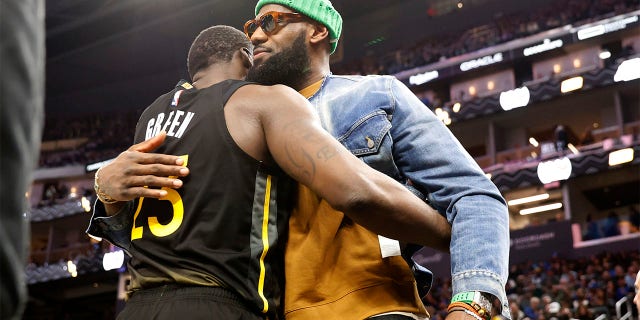 Golden State Warriors forward Draymond Green hugs Los Angeles Lakers forward LeBron James during the game in San Francisco, Saturday, Feb. 11, 2023.