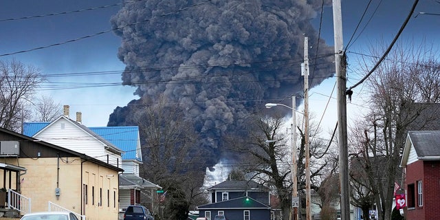 FILE - A black plume rises over East Palestine, Ohio, as a result of a controlled detonation of a portion of the derailed Norfolk Southern trains, Feb. 6, 2023. 
