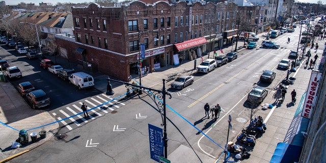 Viewed from a roof, caution tape covers the corner of Bay Ridge Avenue and 5th Avenue where pedestrians were struck on Feb. 13, 2023, in Brooklyn.