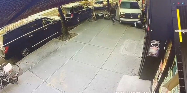 In this photo taken from security video, a man jumps out of the way as a U-Haul truck drives onto the sidewalk on Feb. 13, 2023, in Bay Ridge, Brooklyn.