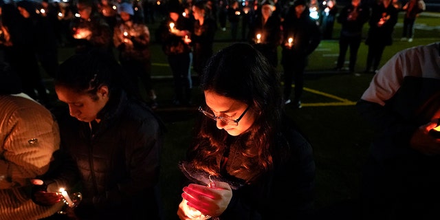 Lexi Bailey attends a candlelight vigil for Alexandria Werner at the Clawson High School football field in Clawson, Michigan on Tuesday, February 14, 2023. 