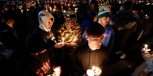 Mourners attend a candlelight vigil for Alexandria Werner at the Clawson High School football field in Clawson, Michigan, Tuesday, February 14, 2023.  