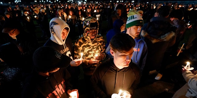 Mourners attend a candlelight vigil for Alexandria Verner at the Clawson High School football field in Clawson, Mich., Tuesday, Feb. 14, 2023.