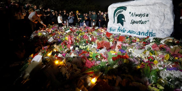 Mourners attend a memorial vigil for Alexandria Verner, Brian Fraser and Arielle Anderson at The Rock on the grounds of Michigan State University in East Lansing, Michigan on Wednesday, February 15, 2023. 