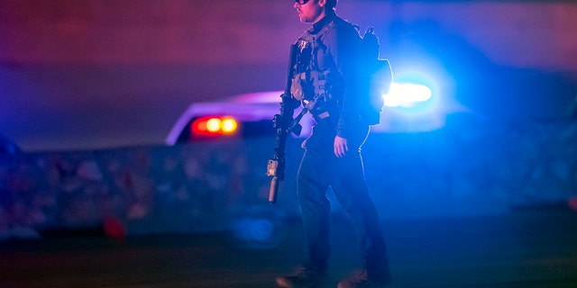 An FBI agent walks outside a shopping mall, Wednesday, Feb. 15, 2023, in El Paso, Texas.