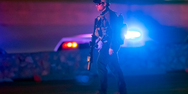 An FBI agent walks outside a shopping mall, Wednesday, Feb. 15, 2023, in El Paso, Texas.