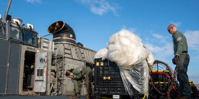 FILE - In this image released by the U.S. Navy, sailors assigned to Assault Craft Unit 4 prepare material recovered off the coast of Myrtle Beach, S.C., Joint Expeditionary Base Little Creek in Virginia Beach, Va., on Feb. 10, 2023. 