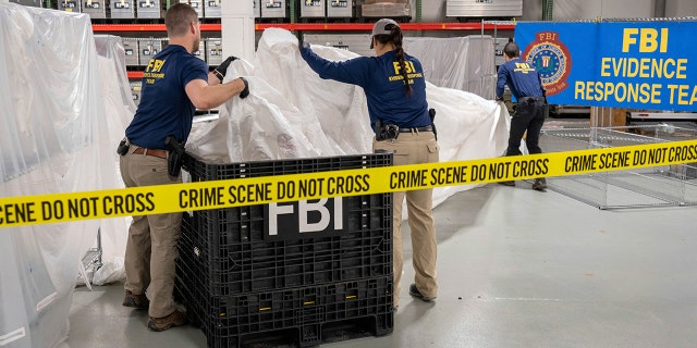 FBI special agents assigned to the evidence response team process material recovered from the high altitude balloon recovered off the coast of South Carolina, Thursday, Feb. 9, 2023, at the FBI laboratory in Quantico, Va. 