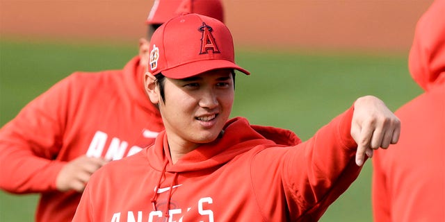 Shohei Ohtani of the Los Angeles Angels gestures during spring training baseball practice Friday, Feb. 17, 2023, in Phoenix. 