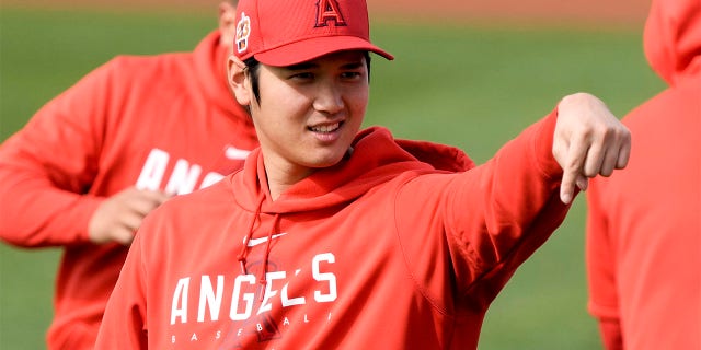 Shohei Ohtani of the Los Angeles Angels gestures during spring training baseball practice Friday, Feb. 17, 2023, in Phoenix. 