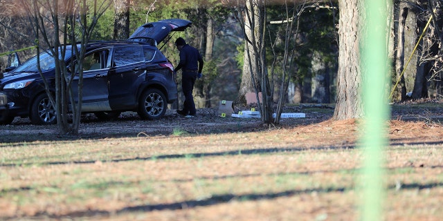 Law enforcement personnel investigate the scene of multiple shootings on Arkabutla Dam Road in Arkabutla, Mississippi, on Friday, Feb. 17, 2023. 