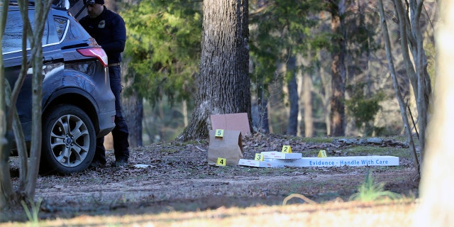 Law enforcement personnel investigate the scene of multiple shootings on Arkabutla Dam Road in Arkabutla, Mississippi, on Friday, Feb. 17, 2023. 