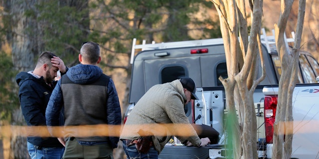 Law enforcement personnel investigate the scene of multiple shootings on Arkabutla Dam Road in Arkabutla, Mississippi on Friday, Feb. 17, 2023. 