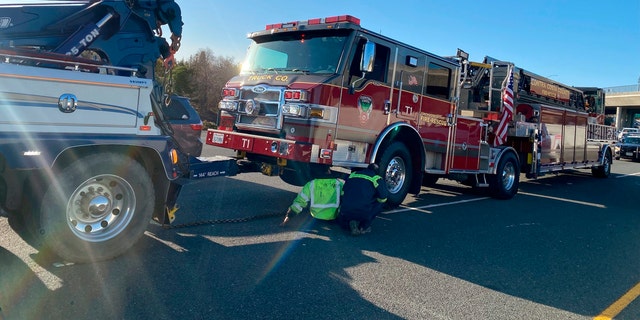 A damaged Contra Costa County fire truck is prepped for towing after it was struck by a Tesla in Contra Costa, Calif., Saturday, Feb. 18,   2023.