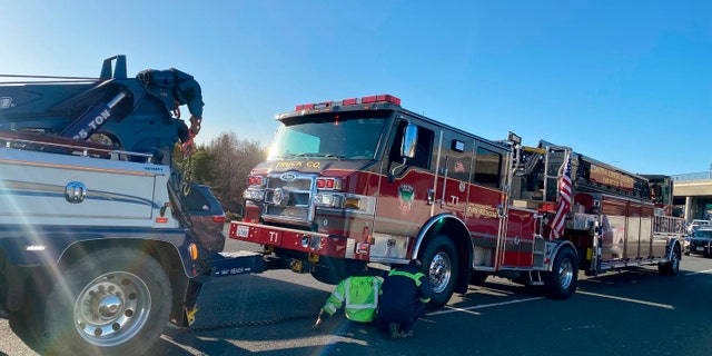 A damaged Contra Costa County fire truck is prepped for towing after it was struck by a Tesla in Contra Costa, Calif., Saturday, Feb. 18,   2023.