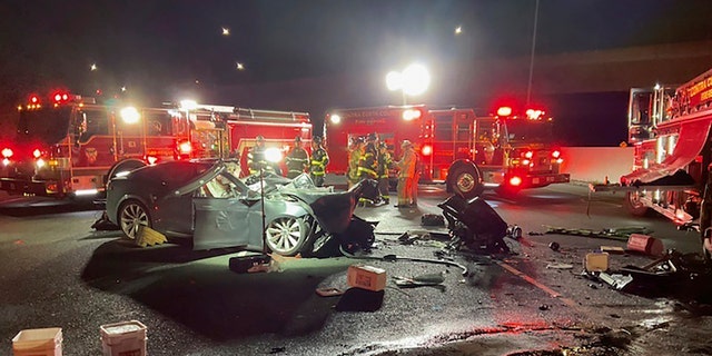 Firefighters work the scene of a fatal accident involving a Tesla and Contra Costa County fire truck early Saturday morning, Feb. 18, 2023, in Contra Costa, Calif.