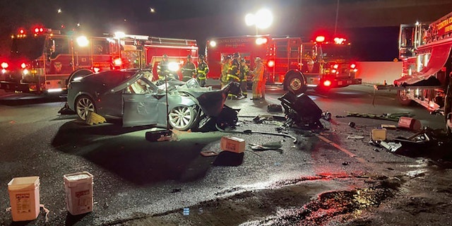 Firefighters work the scene of a fatal accident involving a Tesla and Contra Costa County fire truck early Saturday morning, Feb. 18, 2023, in Contra Costa, Calif.