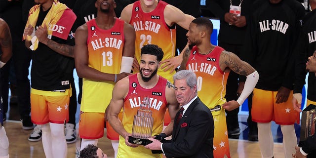 Team Giannis forward Jayson Tatum (0) receives his Most Valuable Player trophy after the NBA All-Star Game on Sunday, February 19, 2023, in Salt Lake City. 