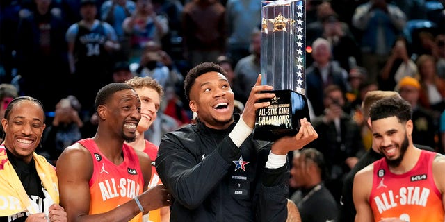 Giannis Antetokounmpo holds up the winning team's trophy after the NBA All-Star Game on Sunday, February 19, 2023, in Salt Lake City. 