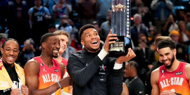 Giannis Antetokounmpo holds up the winning team's trophy after the NBA All-Star Game on Sunday, February 19, 2023, in Salt Lake City. 