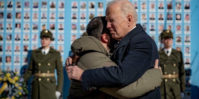 President Joe Biden, right, and Ukrainian President Volodymyr Zelenskyy hug as they say goodbye at the Memorial Wall of Fallen Defenders of Ukraine 