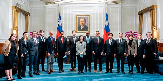 In this photo released by the Taiwan Presidential Office, Taiwan's President Tsai Ing-wen, center, and Taiwanese officials pose for photos with a U.S. delegation led by California Rep. Ro Khanna, sixth from left, during a meeting at the Presidential Office in Taipei, Taiwan on Tuesday, Feb. 21, 2023. 