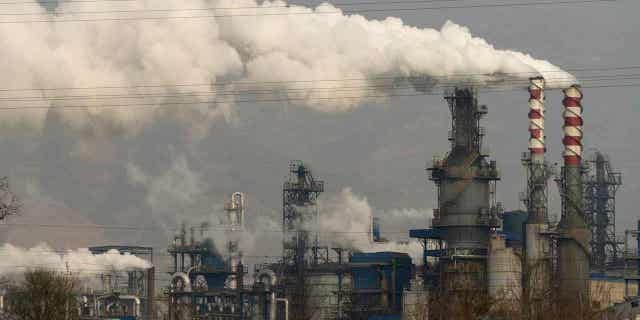 Smoke and steam rise from a coal processing plant in Hejin in central China's Shanxi Province on Nov. 28, 2019. The International Energy Agency on Tuesday, Feb. 21, 2023, accused fossil fuel industries of doing too little to curb methane emissions and undermining global climate goals to limit warming. 