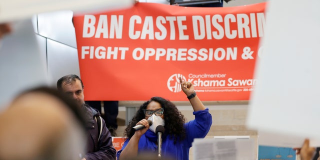 Thenmozhi Soundararajan, founder and executive director of Equality Labs, speaks to supporters and opponents of a proposed ordinance to add caste to Seattle’s anti-discrimination laws rally at Seattle City Hall, Tuesday, Feb. 21, 2023, in Seattle. 